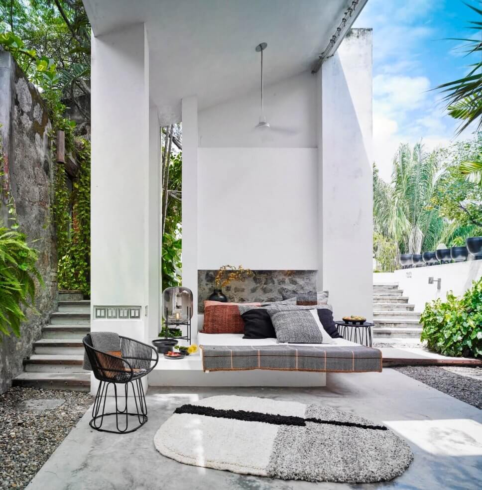 Terrasse mit Teppichen, Kissen und mit Sessel aus Geflecht in einer kolumbianischen Casa