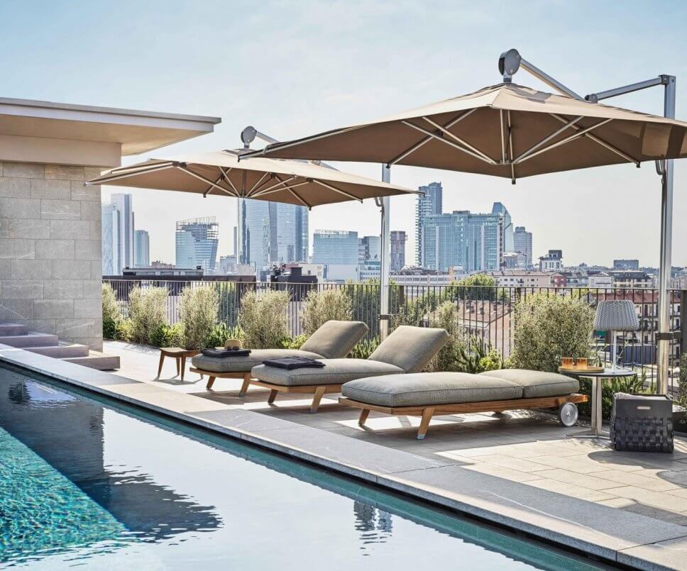 Modernes Sonnenliegen auf Dachterrasse neben Pool