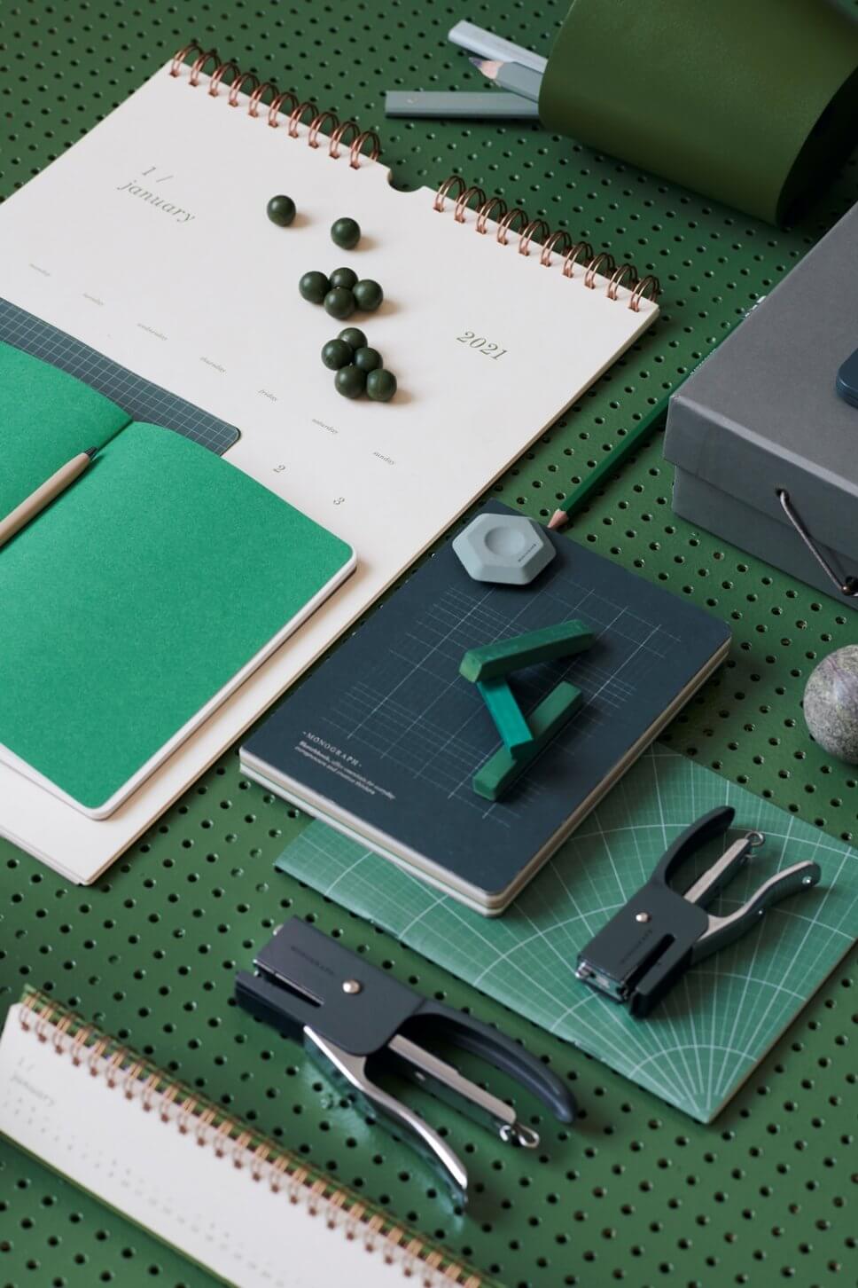 Schreibtisch mit bunten Heften, Stiften und Tacker