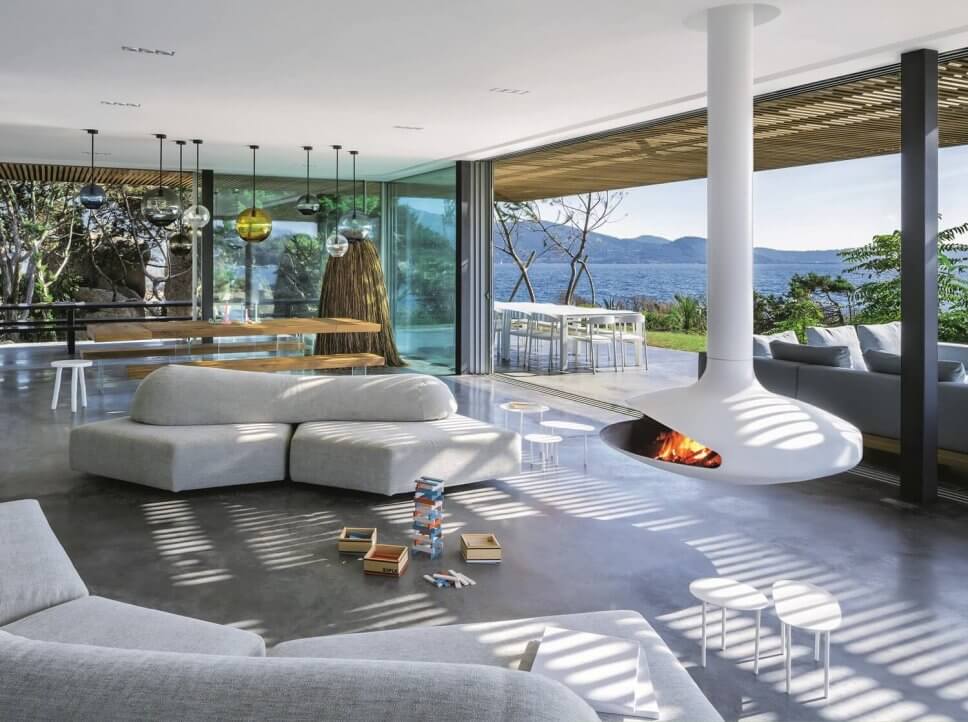 Modern eingerichtetes Wohnzimmer mit Kaminofen im Mittelpunkt