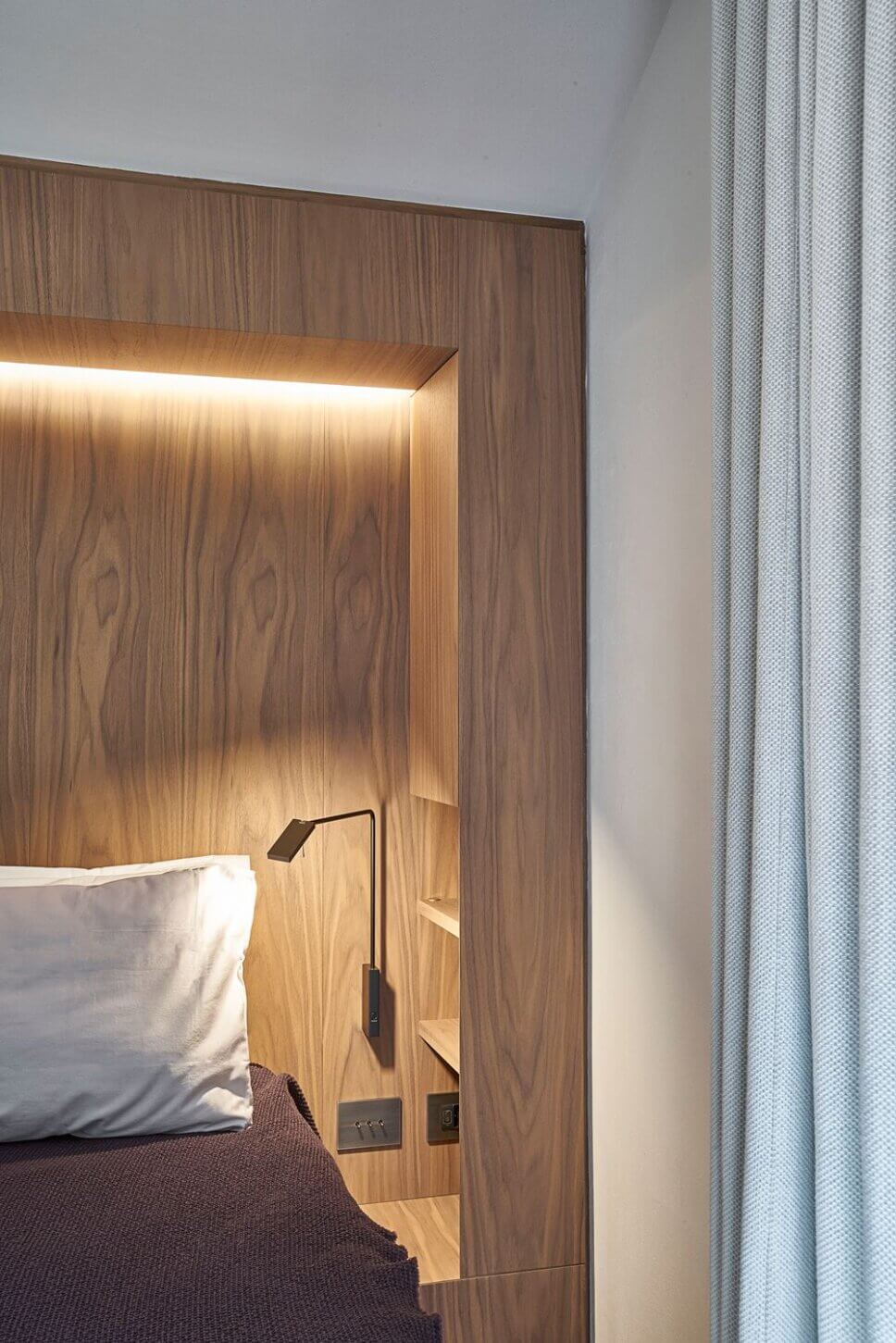 Minimalistisch eingerichtetes Schlafzimmer mit Polsterbett und Einbauschrank