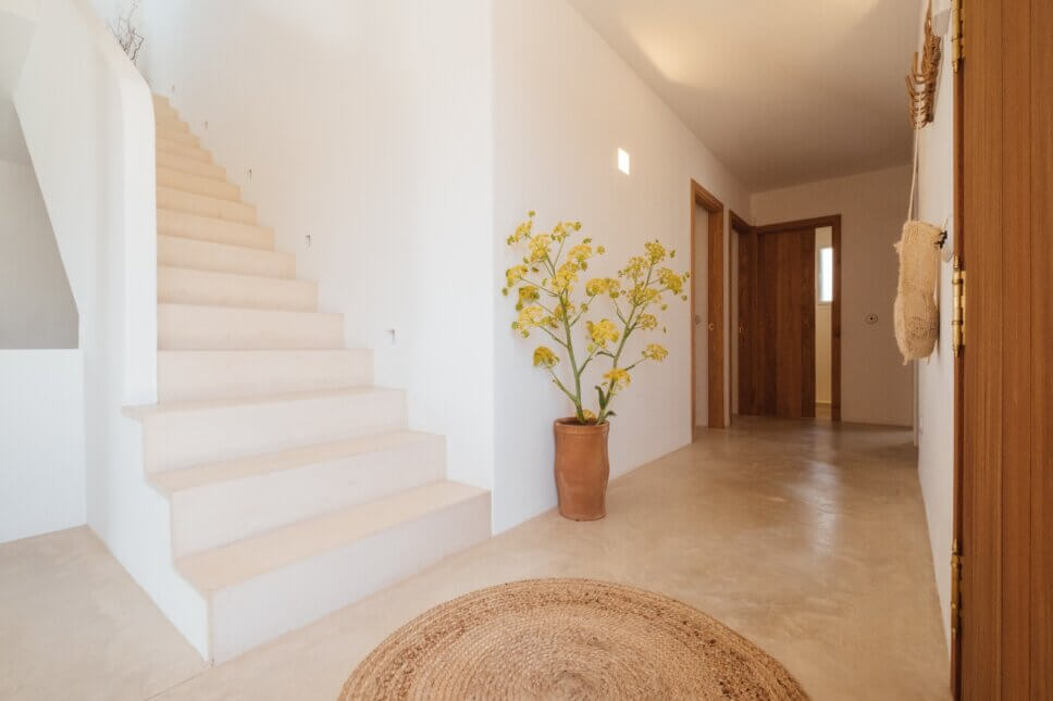 Eingang in moderner spanischer Finca mit Treppe und Tonvase im Vordergrund