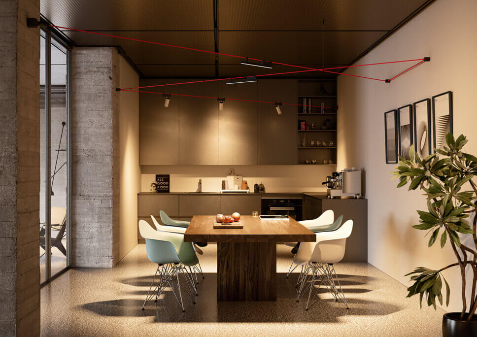 Mit moderner Designerlampe beleuchteter Esstisch in offener Küche