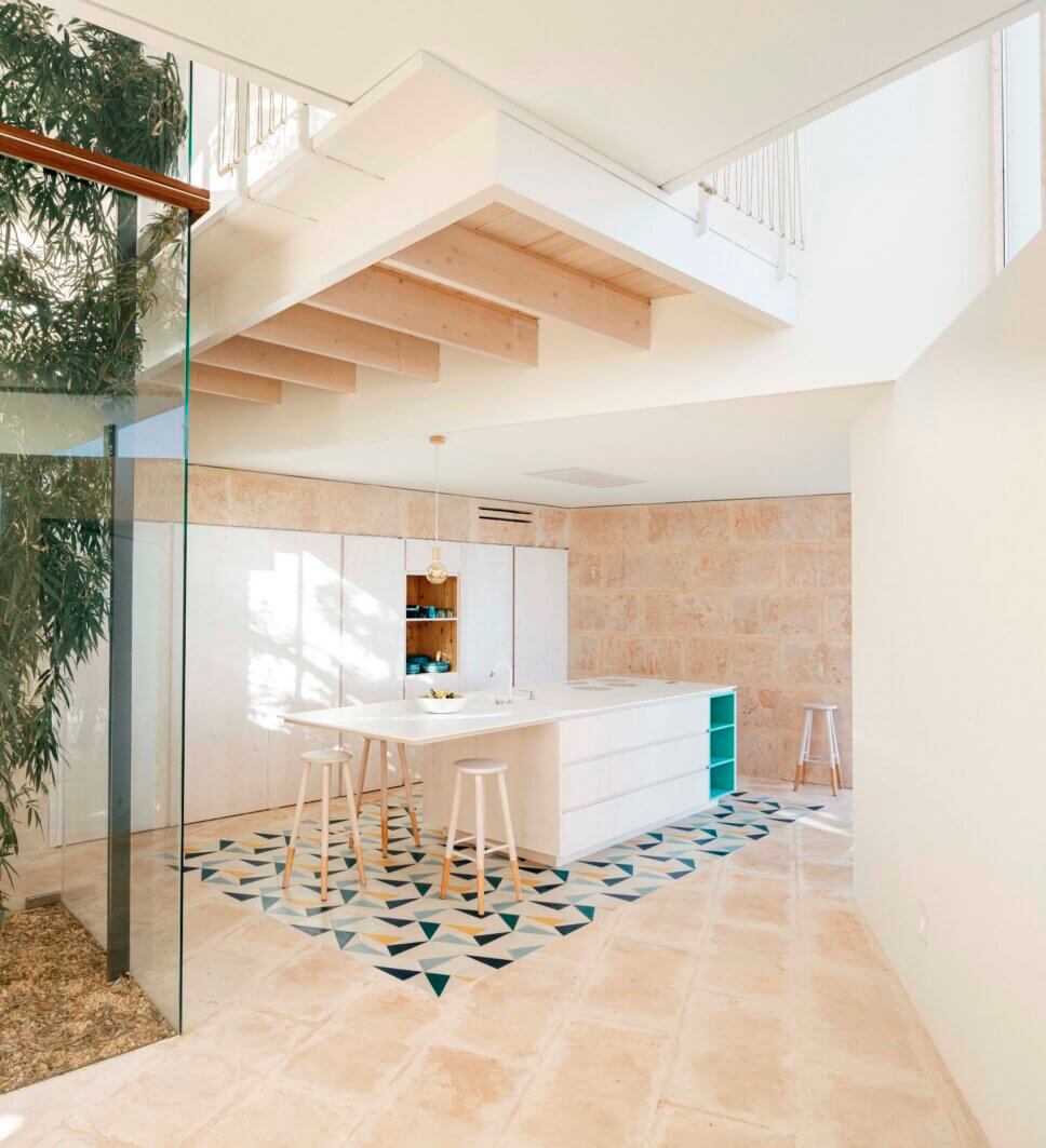 Puristisch eingerichtete offene Küche mit Kochinsel in einem modernen Haus auf Mallorca